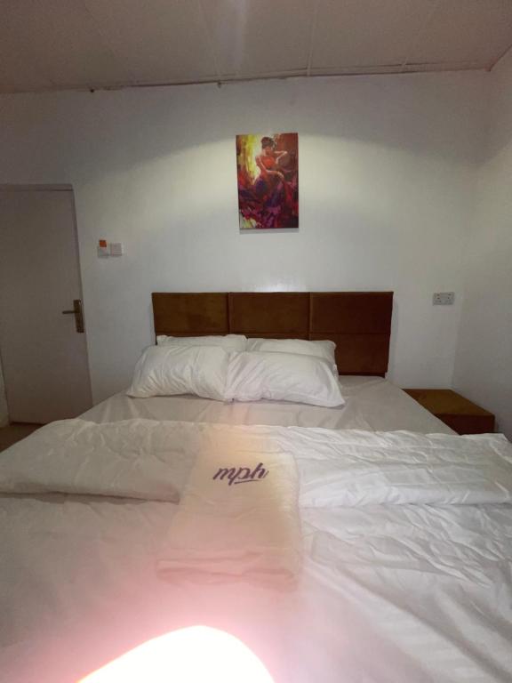 a white bed with a napkin on top of it at MPH in Lagos