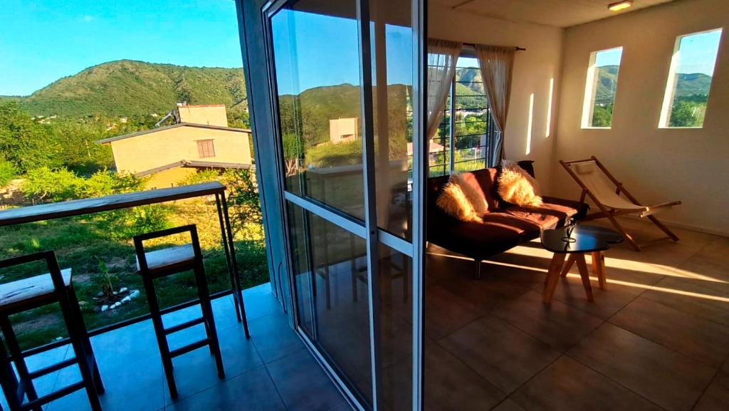 a living room with a couch on a balcony at Balcones de playa de oro in Villa Independencia