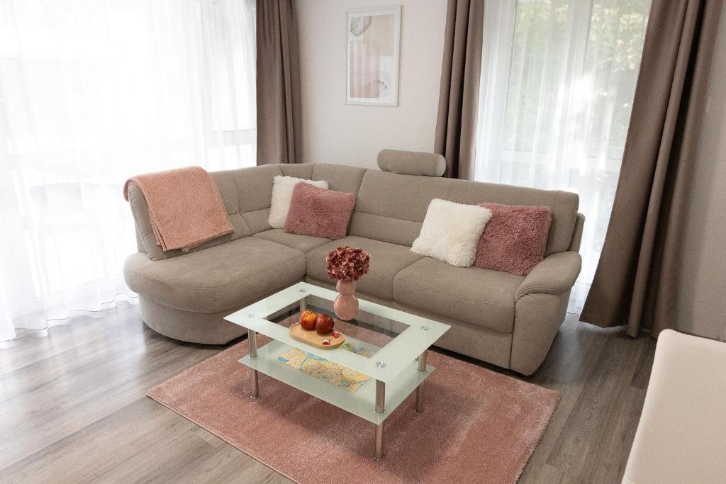 a living room with a couch and a table at SunSuite Szeged in Szeged