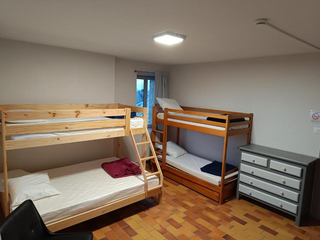 a room with two bunk beds and a desk at La Mansio de Bons in Les Deux Alpes