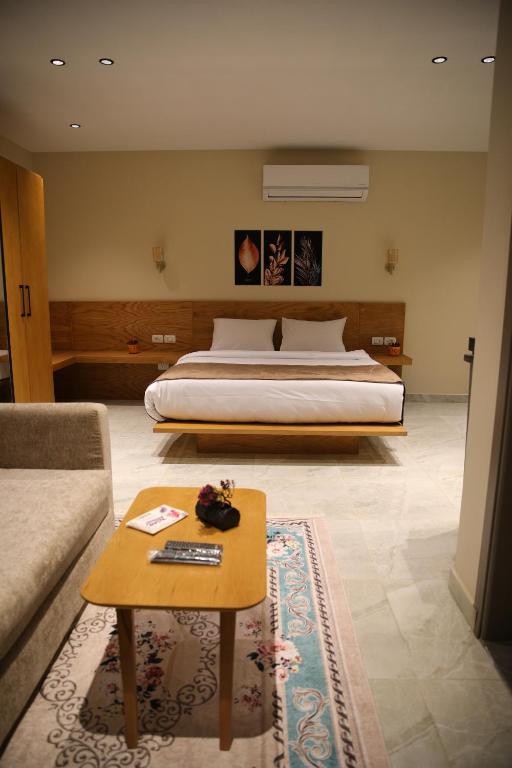 a bedroom with a bed and a coffee table with a couch at Regal view Aparthotel in Cairo