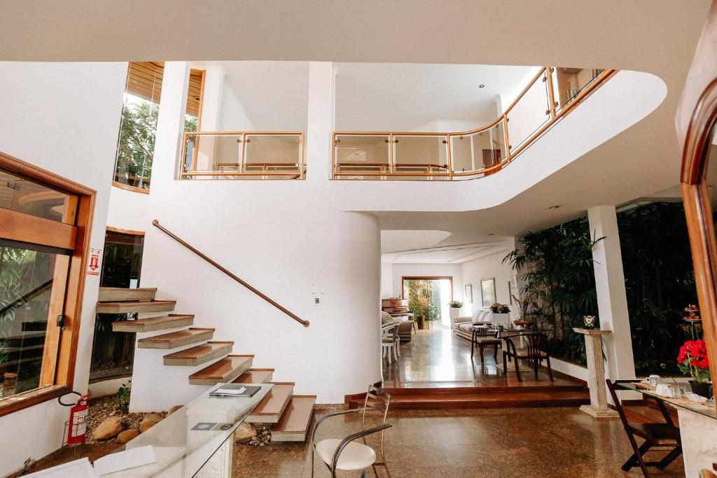 a living room with a staircase in a house at CORTESE HOTEL in Tatuí