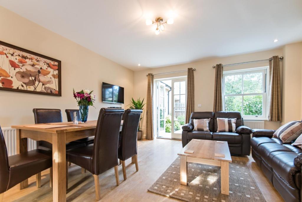 a living room with a table and a couch at Camstay Abbey Street in Cambridge