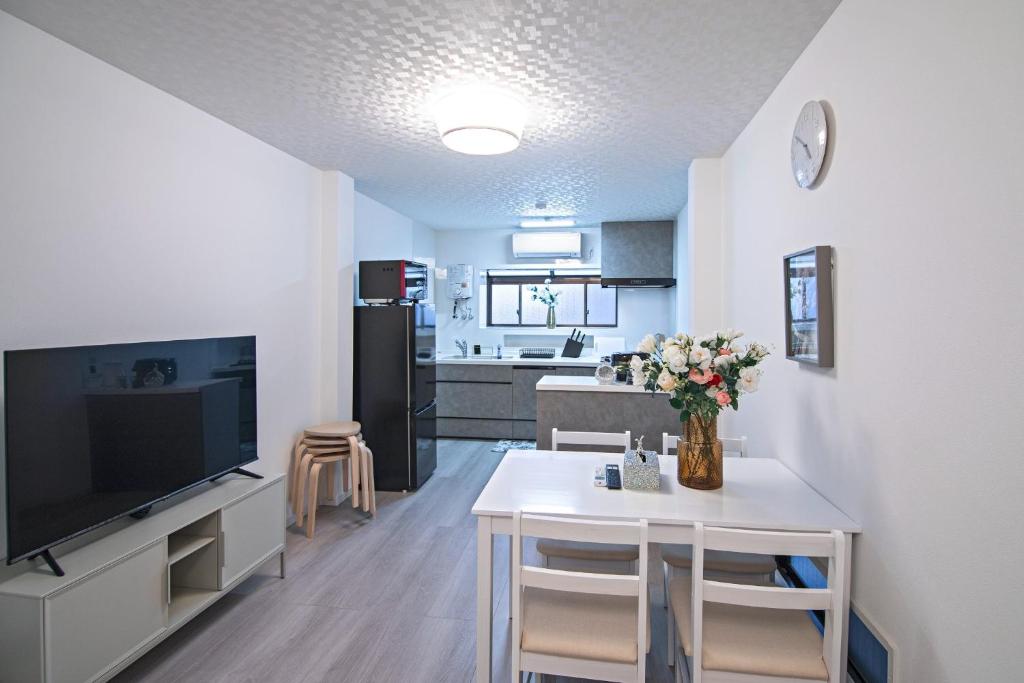 a kitchen and living room with a table and a tv at UMI-Haven Fukushima - Vacation STAY 16109 in Osaka