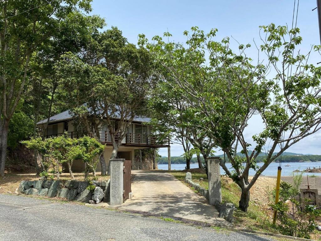 a house on the side of a road with trees at SlowTime - Vacation STAY 75364v in Shima