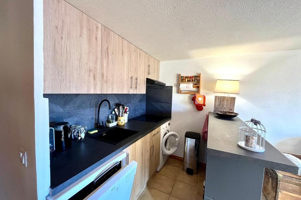 a kitchen with a sink and a counter top at Apartment with balcony and exceptional view in Saint-Gervais-les-Bains