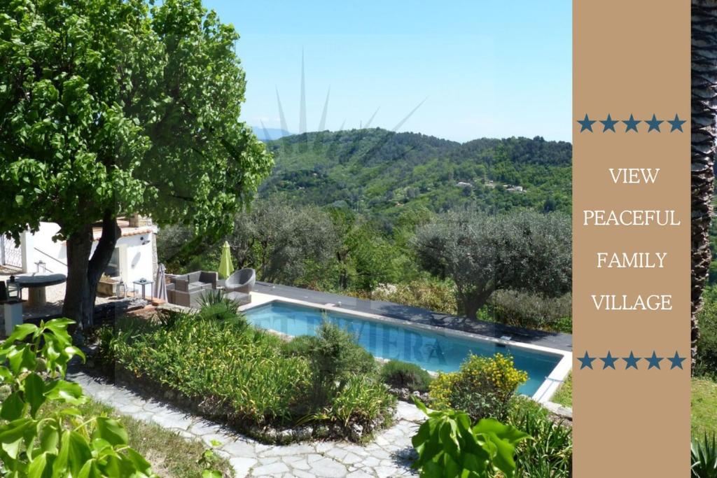 a view of a villa with a swimming pool at Provencal Villa with Stunning Views of the Sea and Mountains in Le Bar-sur-Loup