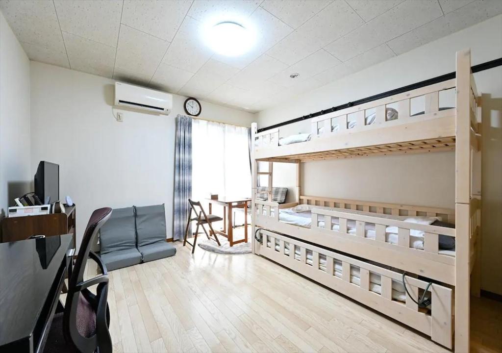 a room with two bunk beds and a table in it at Rose Park Nibankan - Vacation STAY 71056v in Funabashi