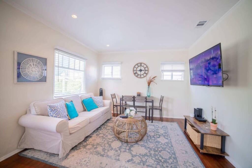 a living room with a couch and a table at Sea View, Flower Garden, A/c, W/d, Renovated in Hermosa Beach