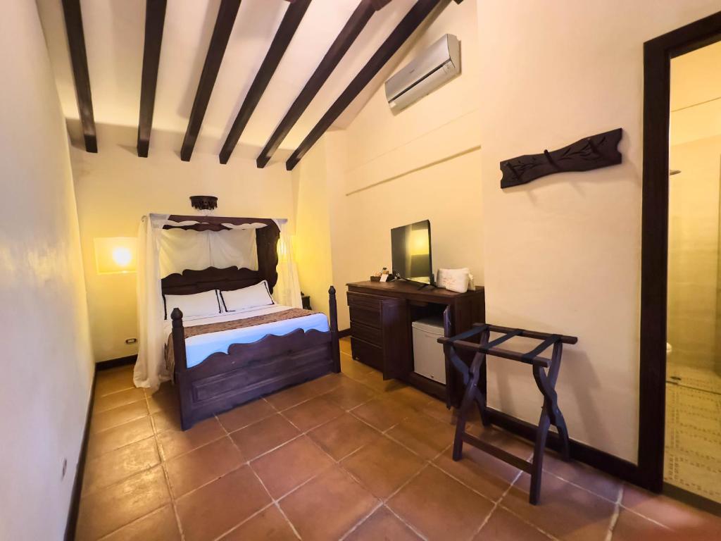 Postel nebo postele na pokoji v ubytování Nueva Granada Hotel Colonial -Centro Histórico-