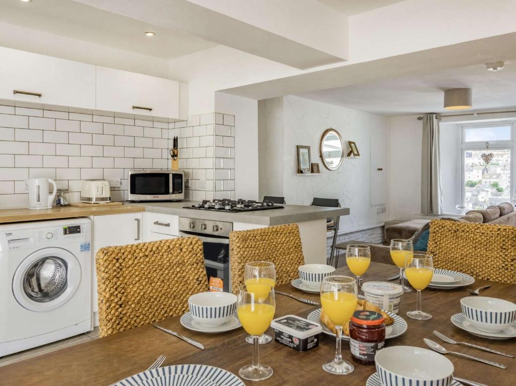 a kitchen with a table with glasses of orange juice at 3 bed property in Brixham 88018 in Brixham