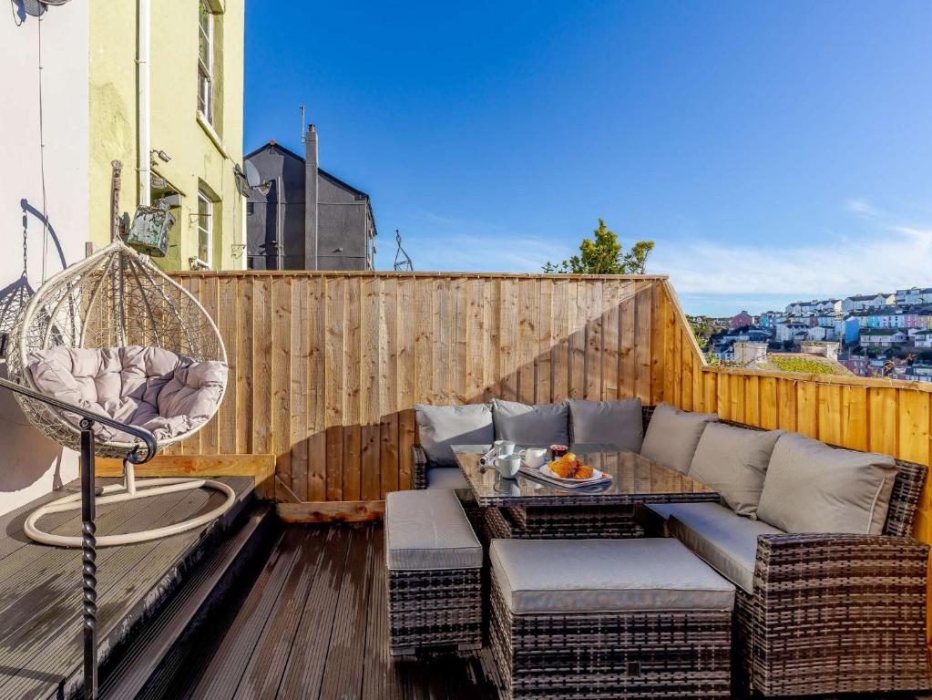 a patio with a couch and a table on a balcony at 3 Bed in Brixham 80655 in Brixham