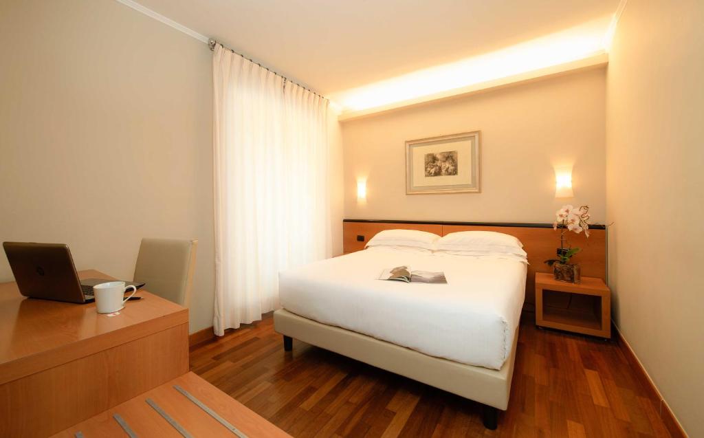 Postel nebo postele na pokoji v ubytování Hotel Fenice