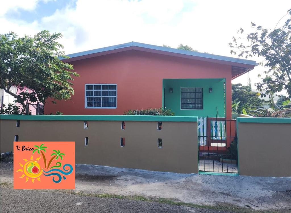 a house with a sign in front of it at Ti Brico Gros Islet Bungalow in Gros Islet
