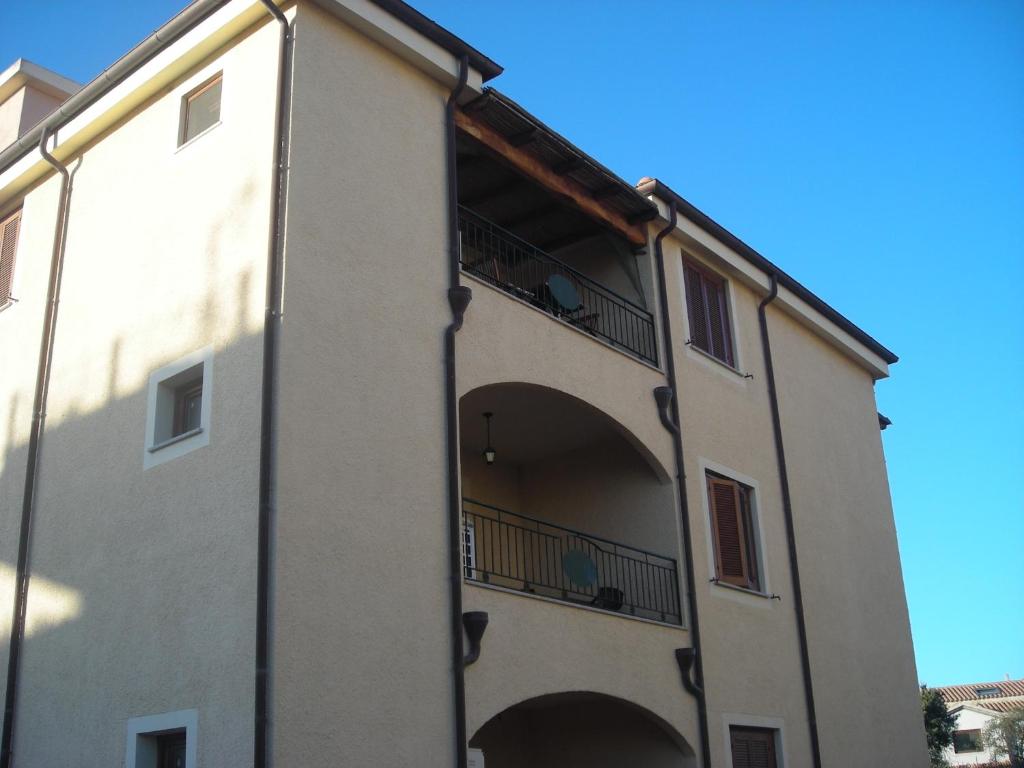 an external view of a building with a balcony at robbyone 2 in Olbia