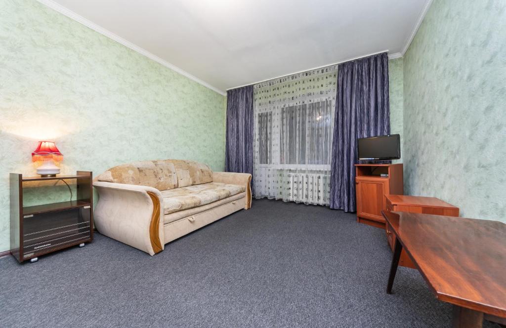 um quarto com uma cama, uma mesa e uma televisão em Уютная однокомнатная квартира возле м.Печерская em Kiev