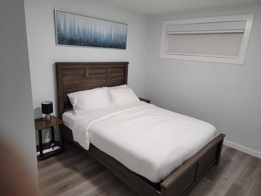 エドモントンにあるPansy Villeのベッドルーム1室(白いシーツ付きのベッド1台、窓付)