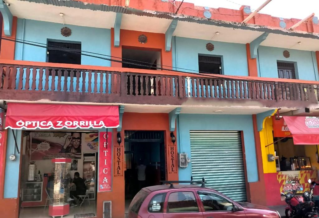 a pink car parked in front of a building at Hostal Madrid in Tapachula
