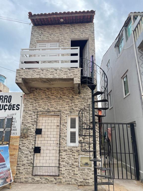 a brick building with a balcony on the side of it at Casa do diego in Aracati