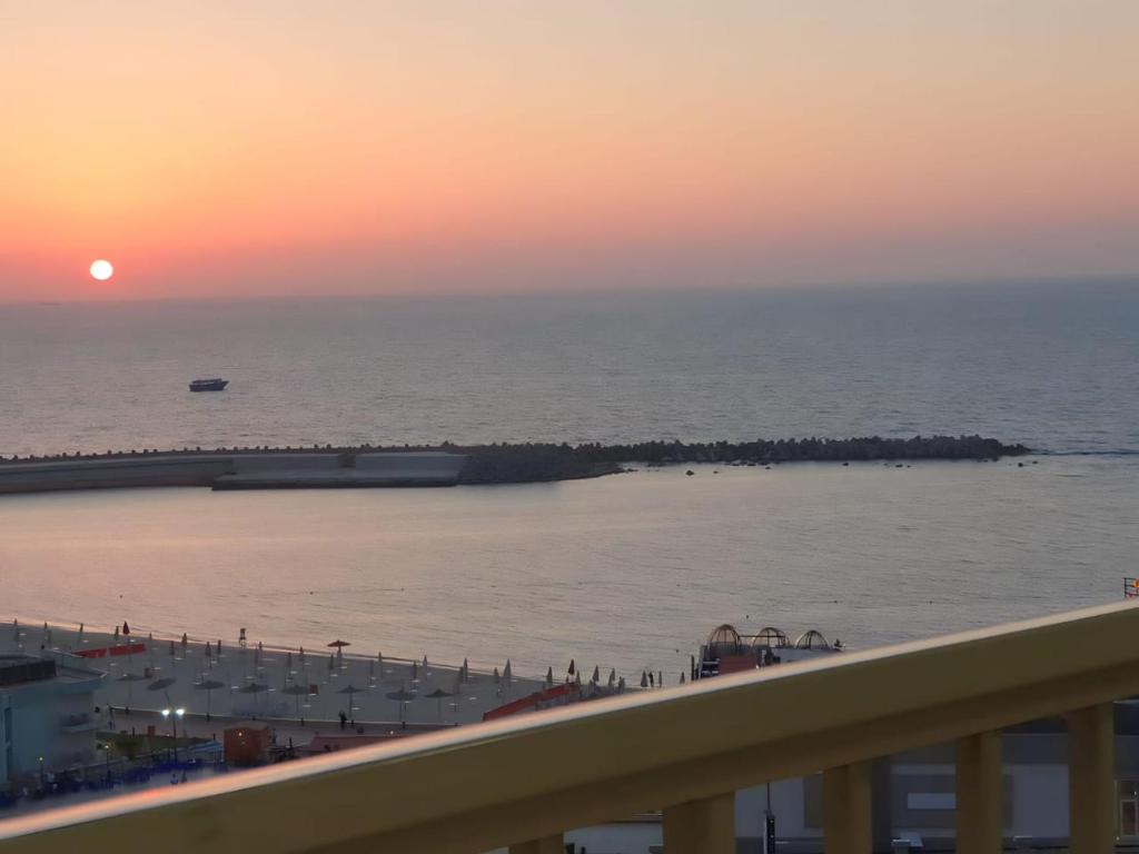 a view of the ocean at sunset from a balcony at City Square شقق فندقية مكيفة باطلالة علي البحر in Alexandria