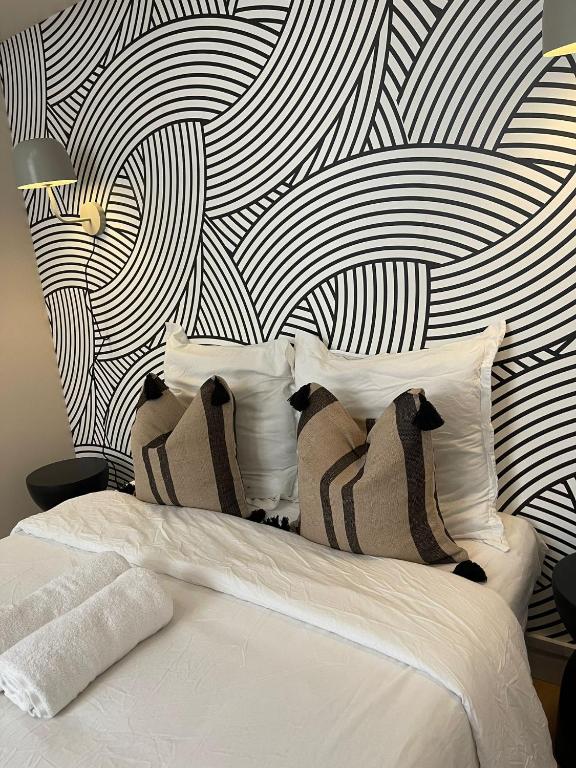 a bedroom with a bed with a black and white wall at Suite Detroit in Lyon