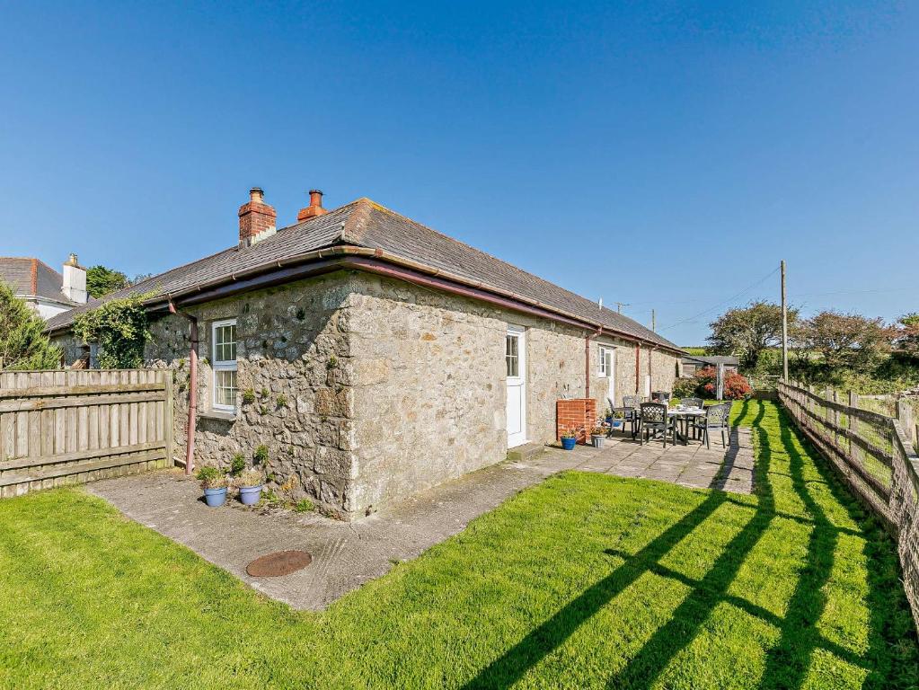 a stone house with a fence and a yard at 3 Bed in Falmouth CONSW in Constantine