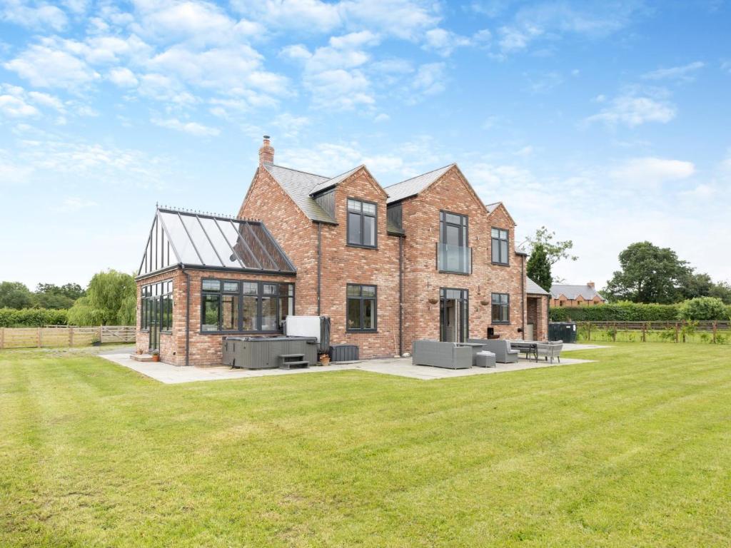 a large brick house with a large grass yard at 5 Bed in Shrewsbury 80686 in Llanymynech