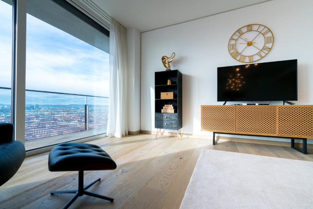 a living room with a television and a large window at Vienna Residence, Donaukanal - Landstraße in Vienna
