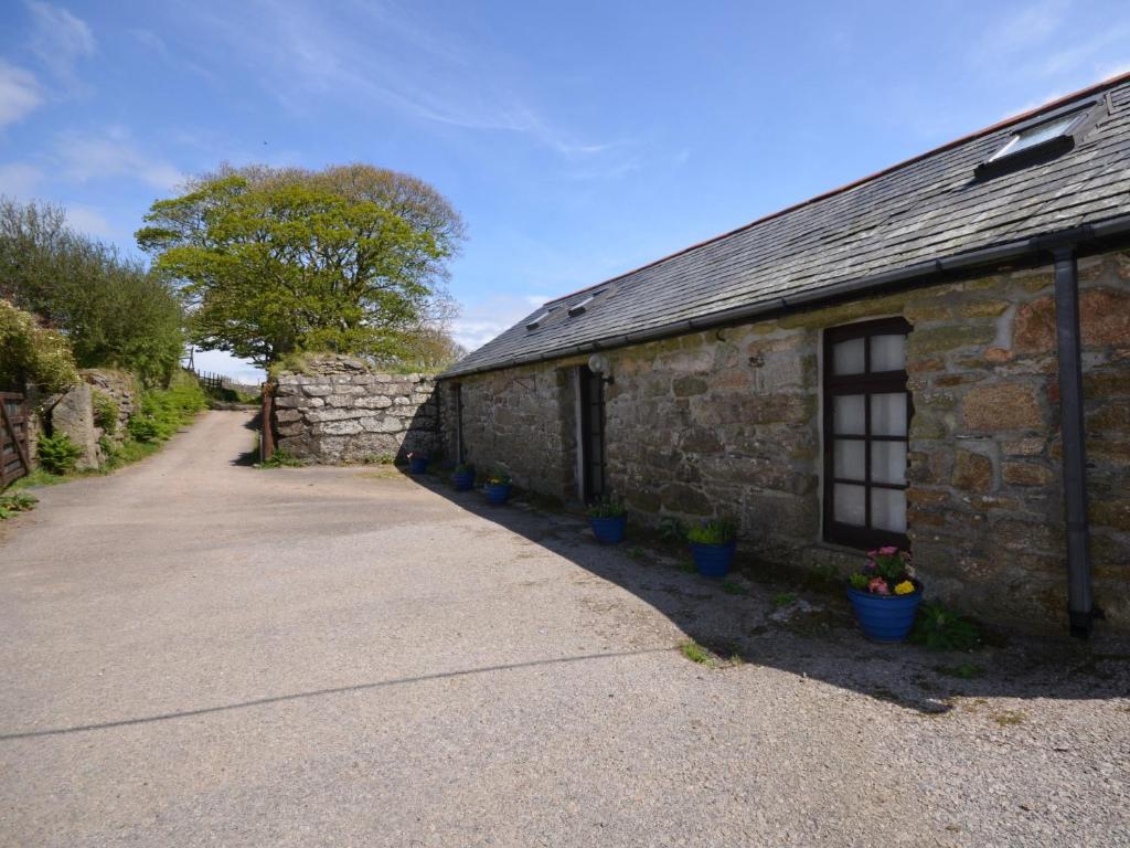a stone building with potted plants in front of it at 2 Bed in Tintagel 51184 in Lanteglos