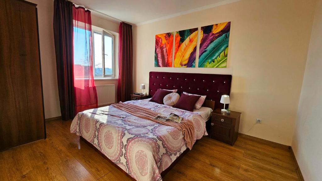 ムカチェヴォにあるBest Two Room Apartmentのベッドルーム1室(ベッド1台付)が備わります。壁には絵画が飾られています。