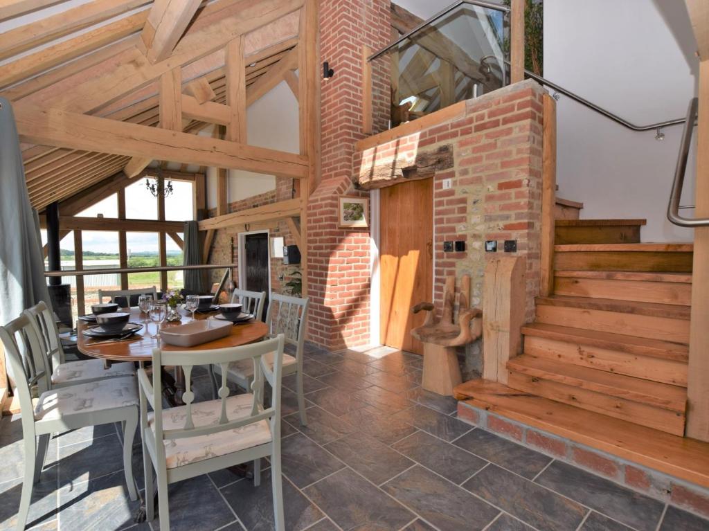 a dining room with a table and a staircase at 2 Bed in Dorchester 41364 in Ansty