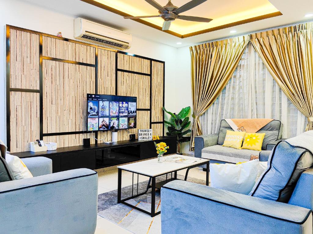 a living room with blue chairs and a tv at Bukit Indah, Pool Table, 16Pax, 5 min to Aeon mall in Johor Bahru