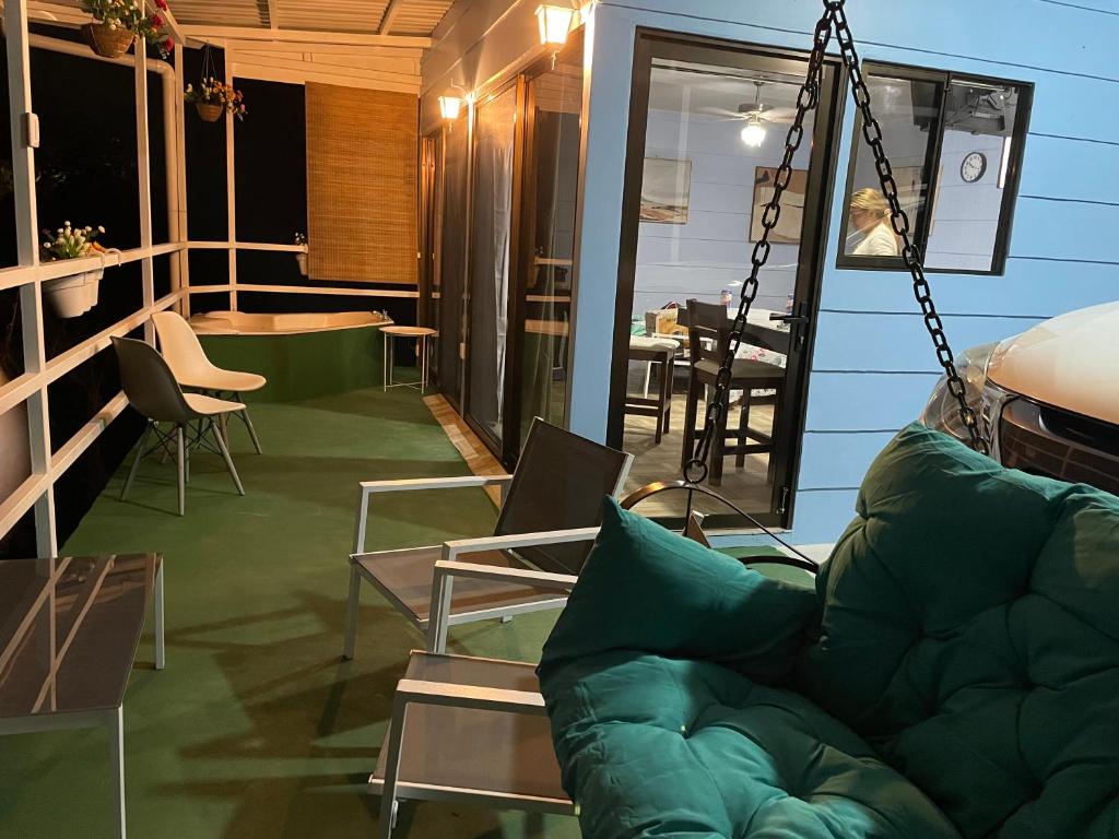 ein Wohnzimmer mit einem grünen Sofa und Stühlen in der Unterkunft Cabaña mirador Jacuzzi 