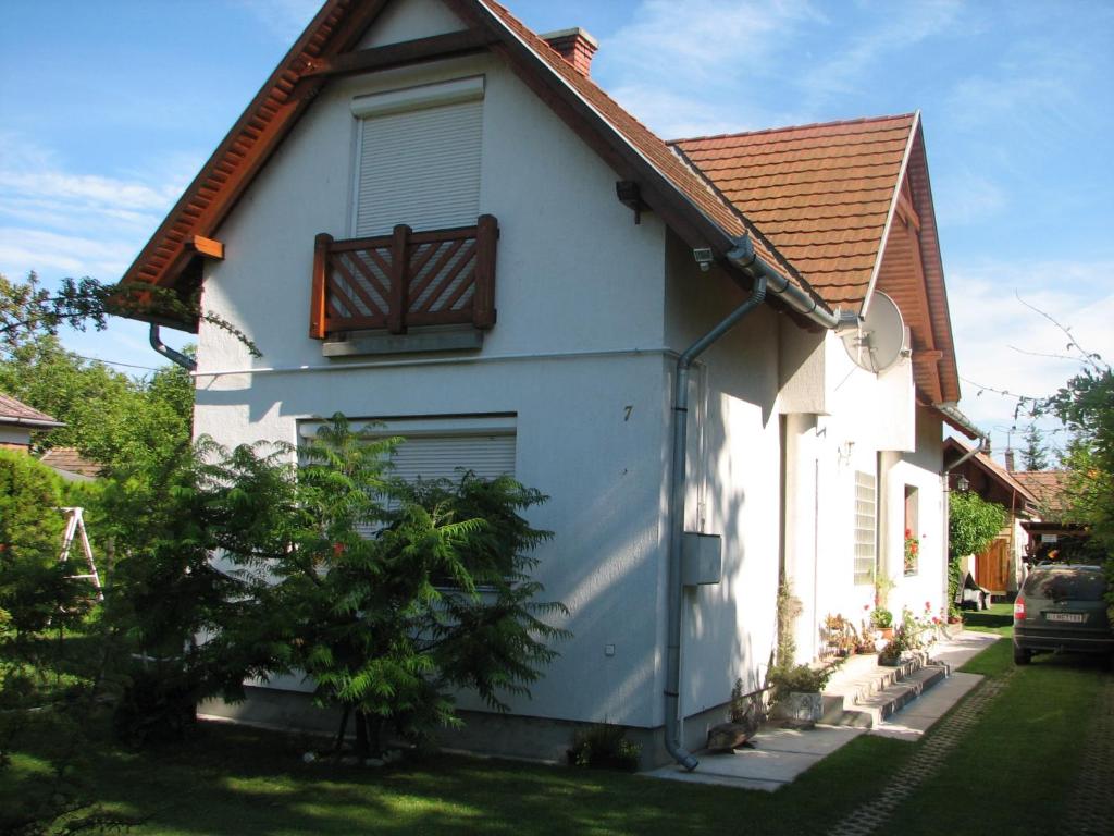 a white house with a window and a roof at Pipacs ház in Balatonlelle