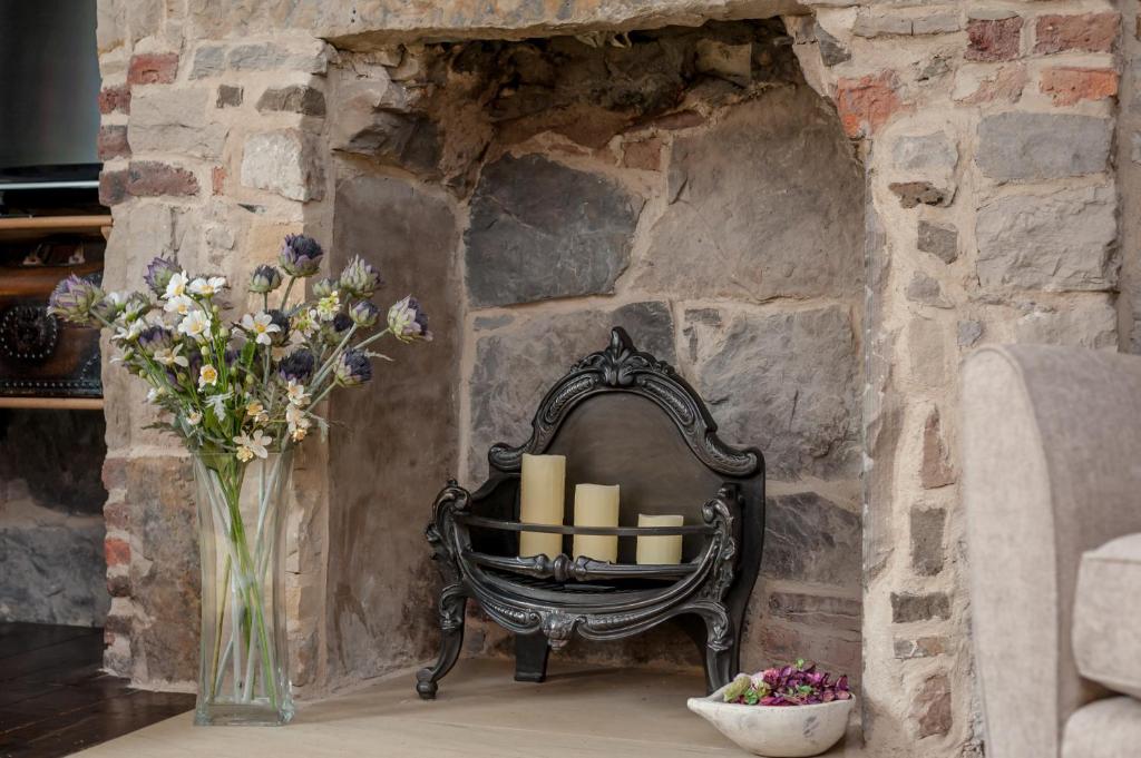 a vase of flowers and candles on a table at Rose Apartment in Edinburgh