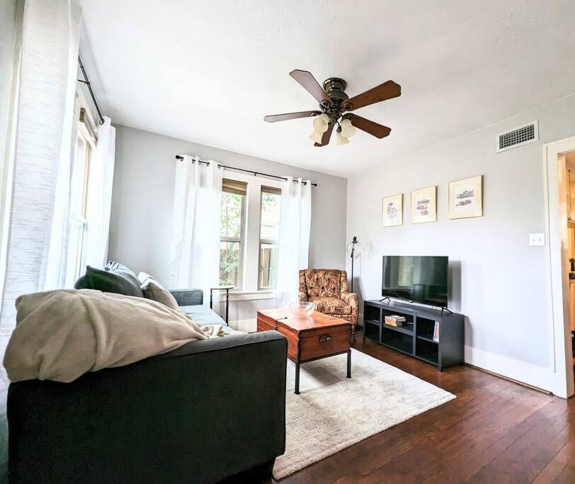 a living room with a couch and a ceiling fan at Charming Home on Callahan in Tyler
