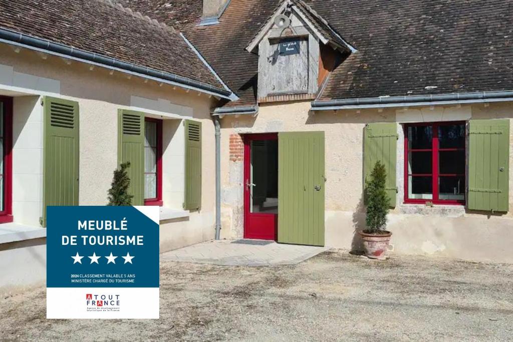 a house with a sign in front of it at Le P'tit Beine in Mont-près-Chambord