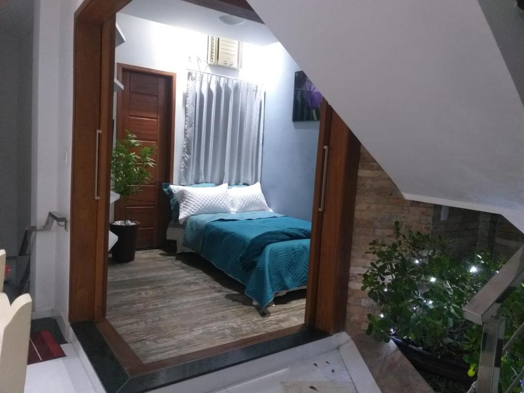a mirror reflection of a bed in a room at Suite star in Duque de Caxias