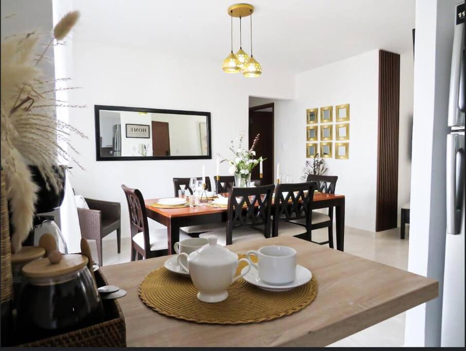 a dining room with a table with chairs and a dining room at Beautiful condo in La Romana near Caleta beach in La Romana