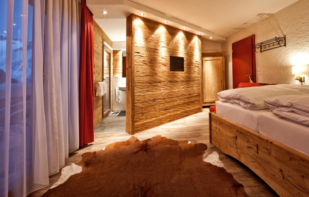 Postel nebo postele na pokoji v ubytování Arosa Vetter Hotel