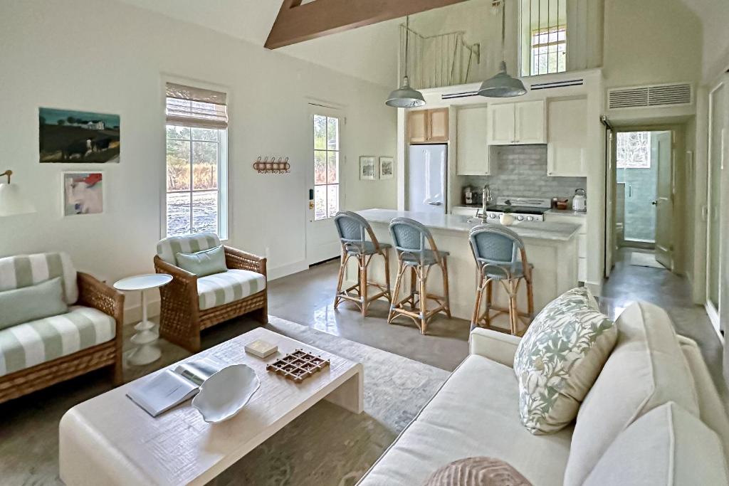 a living room with a couch and a table at Eco-Chic Lake Somerville Area Farmhouse w/ Porch in Brenham
