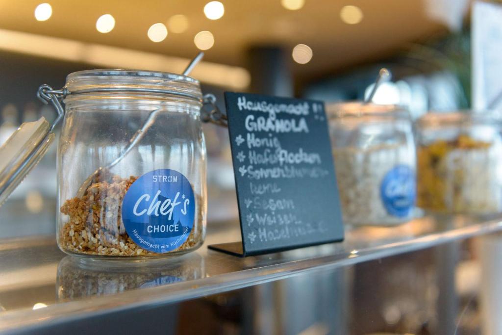 a display of jars of food on a shelf at Atlantic Hotel Sail City in Bremerhaven