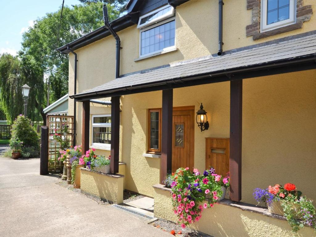 a house with flower boxes on the front of it at 2 Bed in Crickhowell 76431 in Llangenny