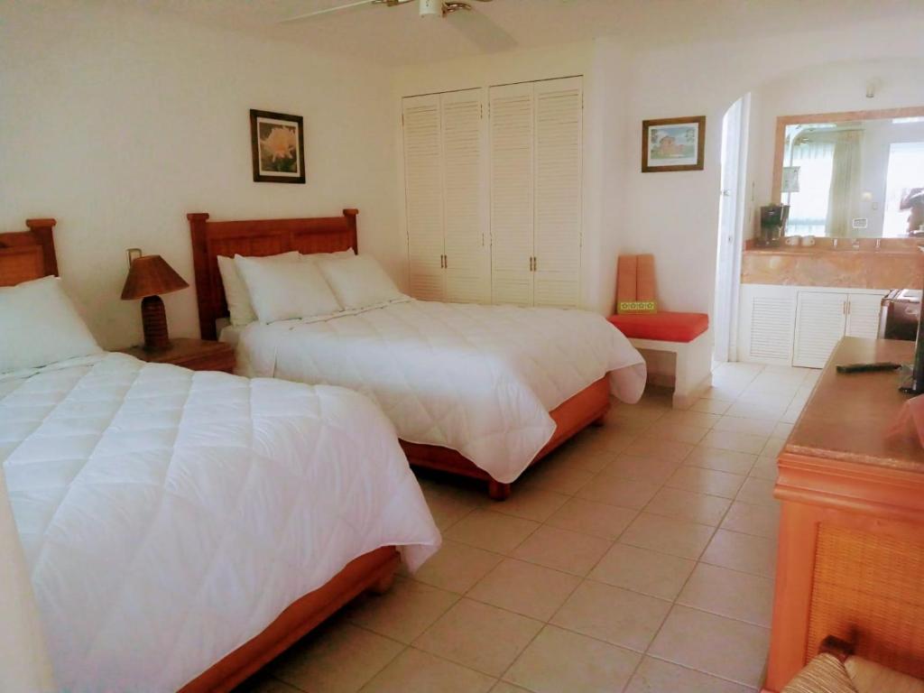 En eller flere senge i et værelse på Nuevo Amanecer