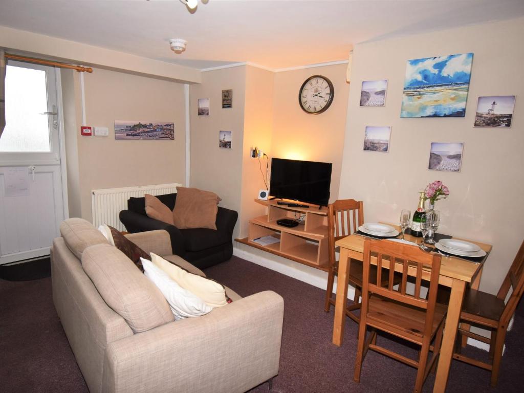 a living room with a couch and a table at 2 Bed in Cosheston FB060 in Cosheston