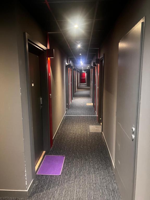 a long hallway with doors and purple mats at EFA in Villeurbanne