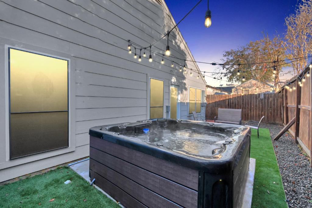 a hot tub in the backyard of a house at 1976 AccessibleGem Jacuzzi Sleep13 ChinaTown 20mins DT in Houston