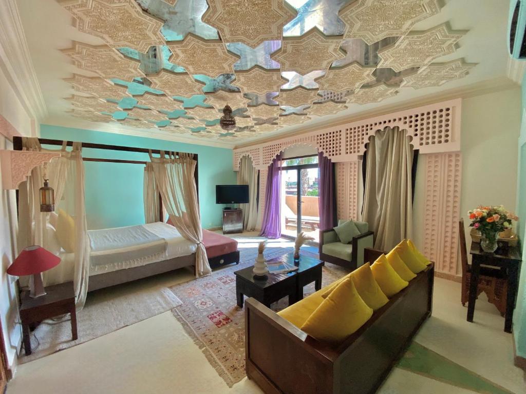 a living room with a ceiling decorated with butterflies at La Villa Des Golfs & PinkCactus in Marrakesh