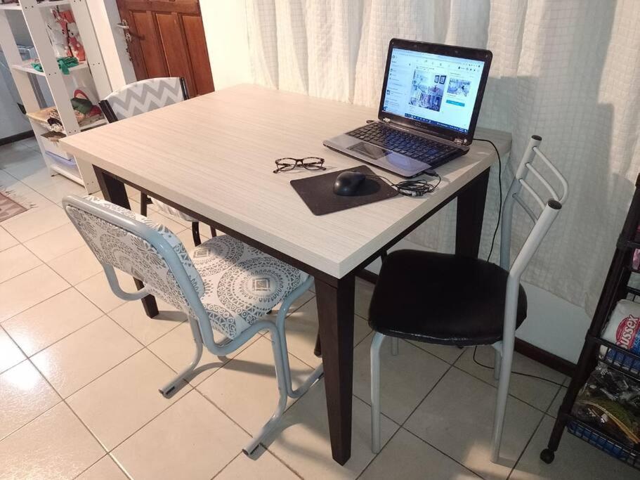 a laptop computer sitting on a table with two chairs at El Refugio al Norte del Fin del Mundo in Río Grande