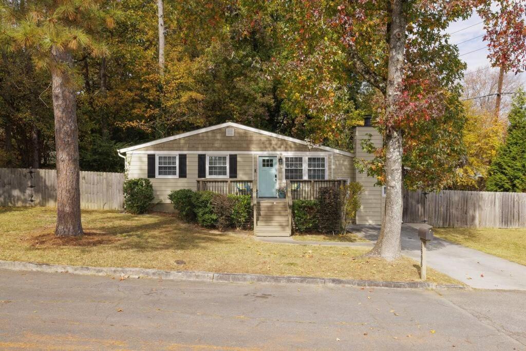 a small white house with a fence and trees at 2BR 2Bath Chamblee Brookhaven Ashford Park Brand new furnishings throughout in Atlanta